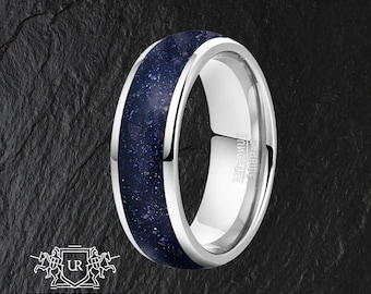 Könnte beinhalten: Ein silberner Wolframcarbid-Ring mit einer blauen Einlage. Die Einlage hat ein gesprenkeltes Muster, das an einen Sternenhimmel erinnert. Der Ring ist mit "TUNGSTEN CARBIDE" beschriftet.