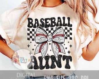 May include: Cream-colored t-shirt with the words "BASEBALL AUNT" in black, retro-style lettering. A baseball-themed bow graphic is centered between the words. The bow has a baseball stitch design. The shirt also has a checkered pattern and star graphics.