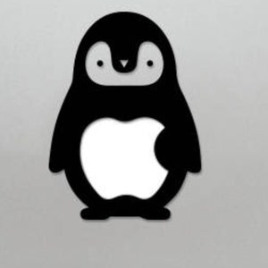 May include: Black and white sticker of a penguin with an apple logo on its belly. The sticker is on a silver laptop.