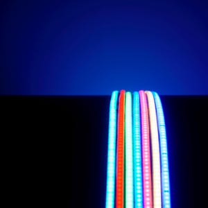 May include: A collection of flexible LED light strips in various colors, including red, green, blue, and pink. The strips are arranged in a row against a dark background, with a gradient blue backdrop.