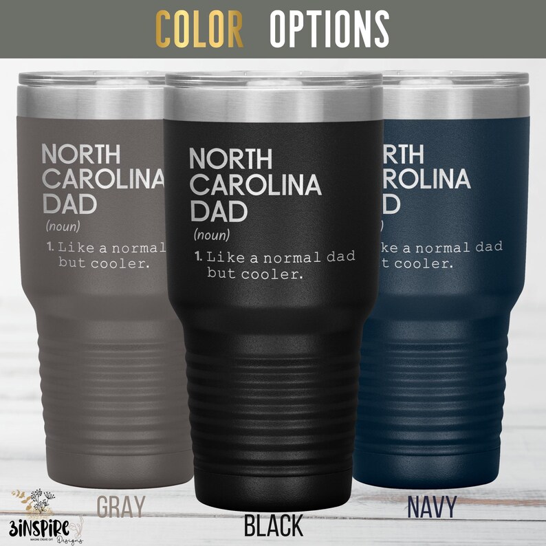 May include: Three insulated tumblers in gray, black, and navy blue. Each tumbler features the text "NORTH CAROLINA DAD" with a definition. The tumblers have a silver rim and a ribbed design.