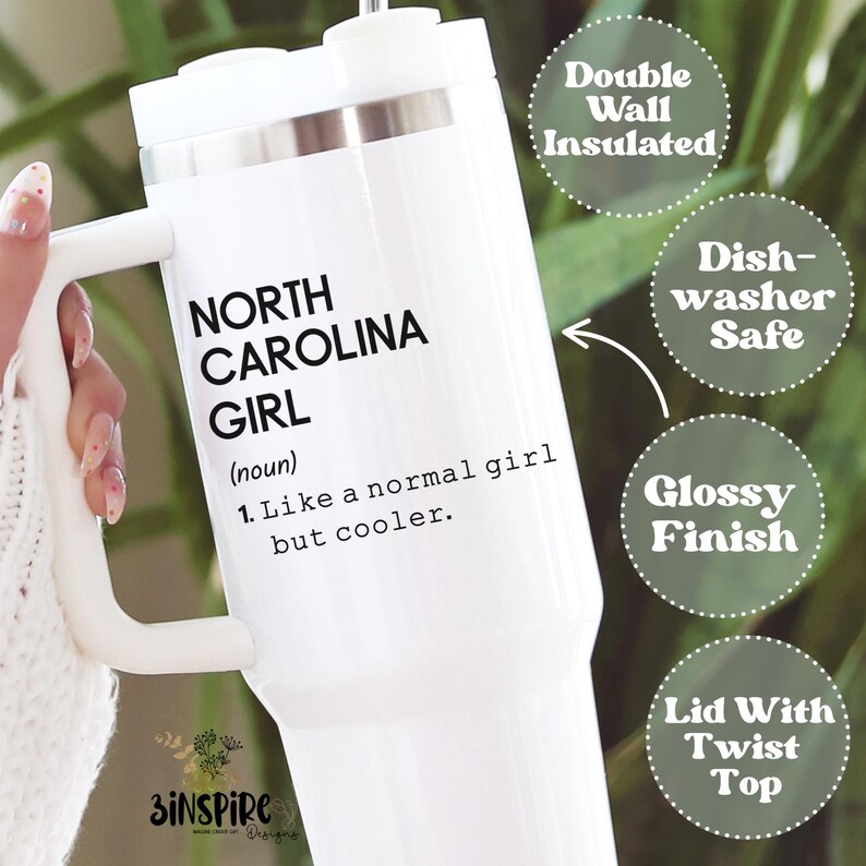 May include: White insulated tumbler with a handle, featuring the text "NORTH CAROLINA GIRL" and a definition. Additional text indicates it is double-wall insulated, dishwasher safe, has a glossy finish, and a lid with a twist top.
