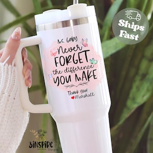 May include: White insulated tumbler with a handle, featuring the text "Ms. Gaby, Never Forget the difference YOU MAKE" in black and pink, with butterfly accents. Includes the words "Thank you! Marshall".