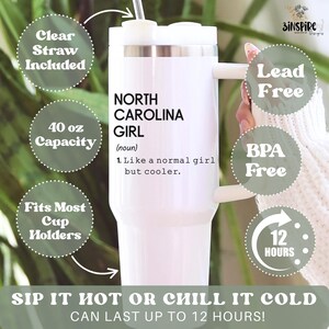 May include: White 40 oz tumbler with a handle, featuring the text "NORTH CAROLINA GIRL" and a definition. Includes a clear straw and is BPA and lead-free. The tumbler fits most cup holders and keeps drinks cold for up to 12 hours.