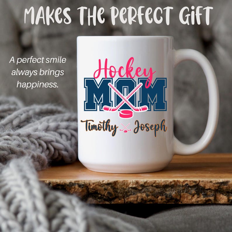 May include: White ceramic mug featuring the text "Hockey Mom" in pink and blue, with hockey sticks and a puck. The names "Timothy" and "Joseph" are printed below. The mug also has the text "Makes the perfect gift" and "A perfect smile always brings happiness."