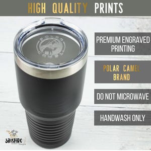 May include: Black Polar Camel tumbler with a clear lid and silver rim. The tumbler has the Polar Camel logo engraved on the lid. Text on the image reads "High Quality Prints", "Premium Engraved Printing", "Polar Camel Brand", "Do Not Microwave", and "Handwash Only".