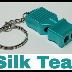 May include: A teal whistle keychain with a silver key ring. The whistle has a ribbed design and two holes for blowing.