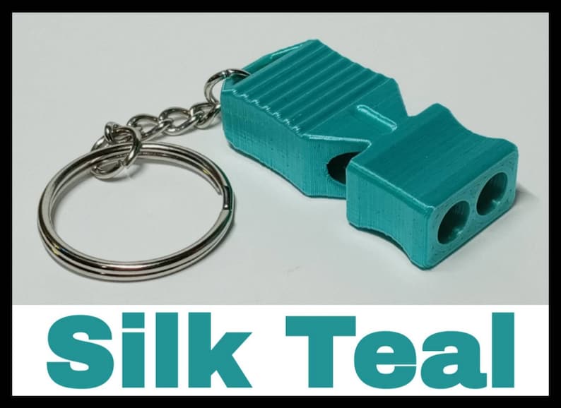 May include: A teal whistle keychain with a silver key ring. The whistle has a ribbed design and two holes for blowing.
