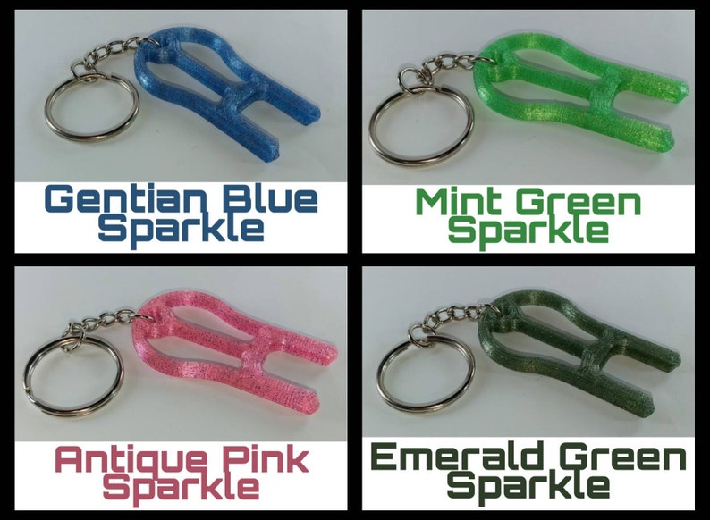 May include: Four keychains with different colored sparkly finishes: Gentian Blue Sparkle, Mint Green Sparkle, Antique Pink Sparkle, and Emerald Green Sparkle.