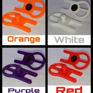 May include: Four 3D printed plastic tools in different colours: orange, white, purple, and red. Each tool has a small magnet and a small nub on the bottom.