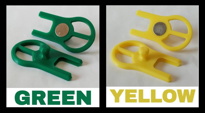 May include: Two plastic tools, one green and one yellow, with a magnet and a small knob. The tools are designed to help with a specific task.