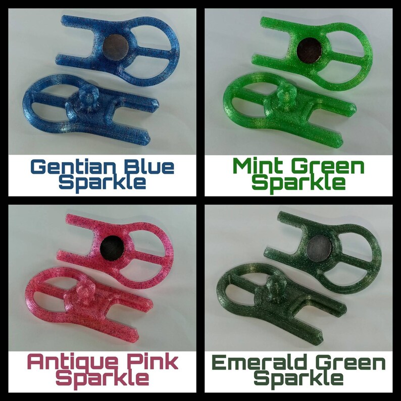 May include: Four different coloured plastic keychains with a sparkly finish. The keychains are shaped like a figure eight with a small circle in the centre. The colours are Gentian Blue Sparkle, Mint Green Sparkle, Antique Pink Sparkle, and Emerald Green Sparkle.