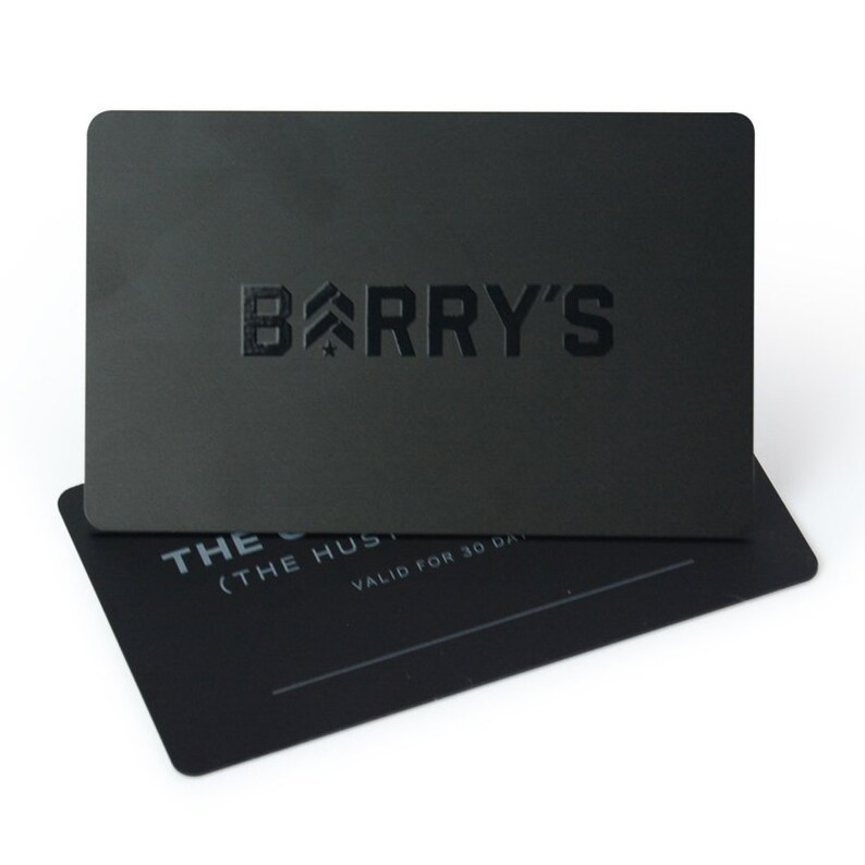 May include: Black gift card with the text "BARRY'S" in white embossed lettering. The card has a small star and an arrow above the "B". The text "THE" and "(THE" are visible on the bottom of the card.