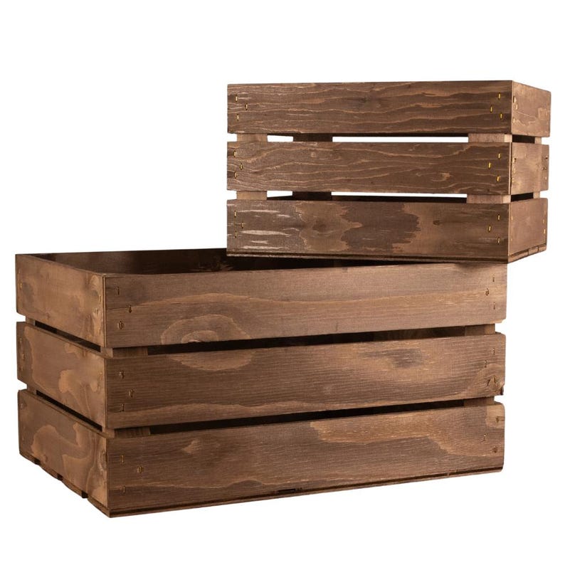 May include: Two wooden crates, one stacked on top of the other. The top crate is smaller and has a single divider. The bottom crate is larger and has two dividers. Both crates are made of brown wood and have a rustic appearance.