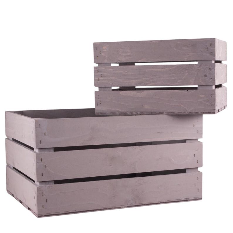 May include: Two wooden crates, one stacked on top of the other. The crates are a light gray color and have a rustic look. The larger crate has three horizontal slats, while the smaller crate has two.