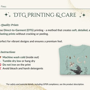 May include: A pale green t-shirt with a watercolour design of a raven, moon, and floral elements. The image also includes care instructions and information about DTG printing.