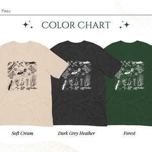 May include: A color chart displays three t-shirts: soft cream, dark grey heather, and forest green. Each shirt features a white graphic design. The text "Neverland Pines" and "COLOR CHART" are at the top. The bottom of the image labels each shirt's color.