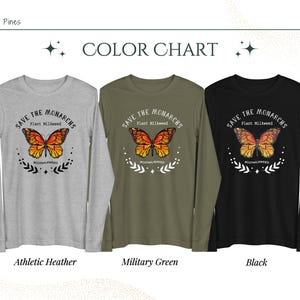 K&ouml;nnte beinhalten: Drei Langarm-Shirts mit einem Schmetterlingsmotiv und dem Text "Save the Monarchs Plant Milkweed #rootmilkweed". Die Shirts sind in den Farben Athletik-Heather, Milit&auml;rgr&uuml;n und Schwarz erh&auml;ltlich.