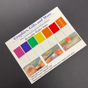 May include: A white card with the text "Graphics, Gifts and More" and "Reusable Wallet Tabs". The card features a rainbow of colored tabs and instructions for use. The card also includes the text "etsy.com/shop/GraphicsGiftsandMore".