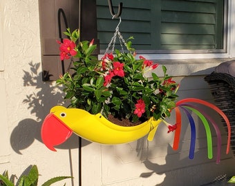 Sunny the Parrot.  Bright, colorful, and classy. Add a plant that hangs/grows out, it will look like wings on the planter. :) Definite Fav.