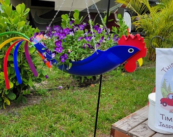 Betty the Blue Rooster.  Betty is a beautiful, bright cobalt blue Rooster with a deep red crown and yellow beak. Definitely eye catching!