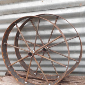 A pair of 24&quot; steel wagon wheels , rustic art Bar b q pits wagons etc, Barbeque