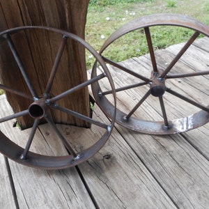 A pair of 12&quot; steel wagon wheels , rustic art Bar b que pits wagons etc,
