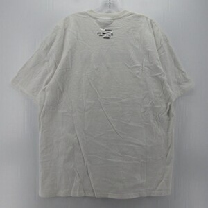 May include: A white short-sleeved t-shirt with a small logo near the neckline. The shirt is hanging on a hanger against a plain white background. The fabric appears to be slightly wrinkled.