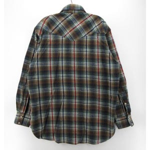 May include: A long-sleeve button-down shirt featuring a plaid pattern in shades of dark green, brown, and grey with thin red vertical and horizontal stripes. The shirt has a pointed back yoke, a standard collar, and buttoned cuffs on the sleeves.