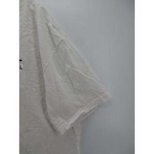 May include: A white short-sleeved t-shirt with a visible logo on the front. The shirt is made of a soft, slightly wrinkled fabric. The sleeve is visible in the image.