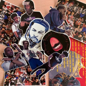 May include: A collection of colorful stickers featuring various images of people, including a person with a microphone, a person with a crown, and a person with a red tongue. The stickers have text on them, including "Bougie Ratchet" and "Moody Mast".
