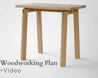 May include: A light-colored wooden side table with a rectangular top and four cylindrical legs. The table is constructed with visible joinery. The text "Woodworking Plan + Video" is at the bottom of the image.