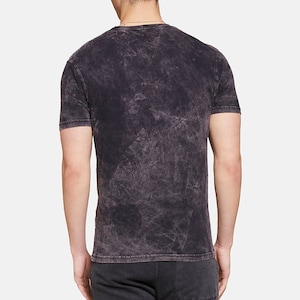 May include: A black acid wash t-shirt with a crew neck.