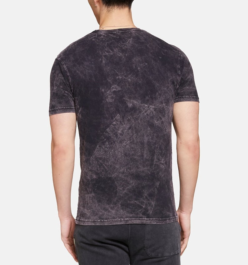 May include: A black acid wash t-shirt with a crew neck.