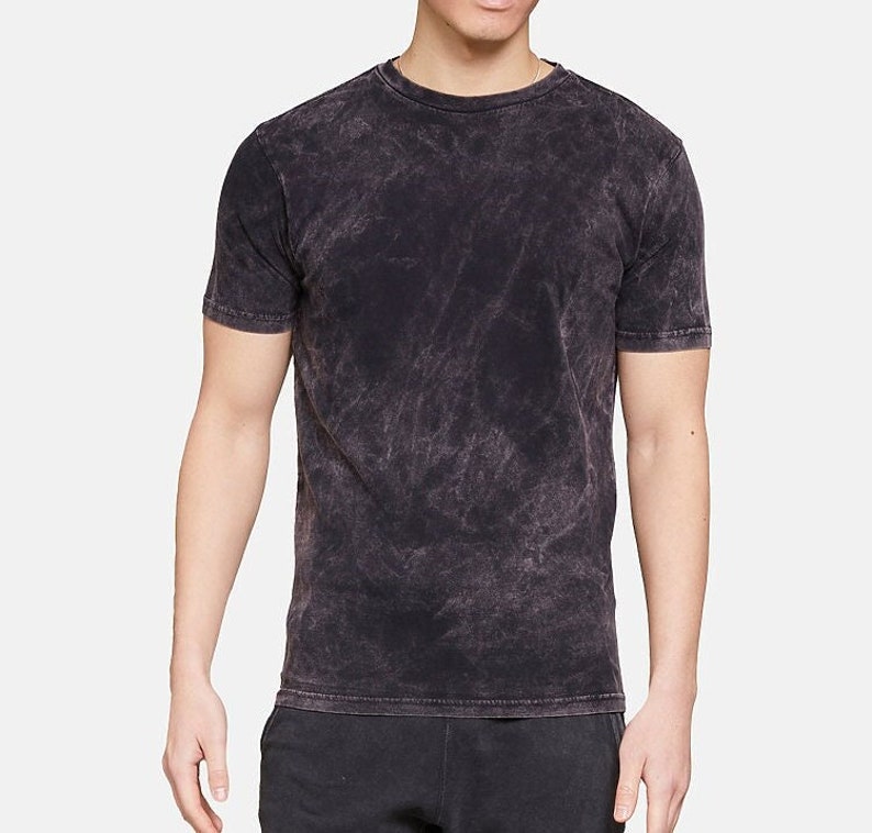 May include: A black acid wash t-shirt with a crew neck.