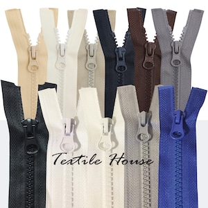 May include: Assortment of zipper pulls in various colours, including black, white, brown, grey, and blue. The zippers are made of plastic and have a metal slider. The text "Textile House" is visible in the centre of the image.