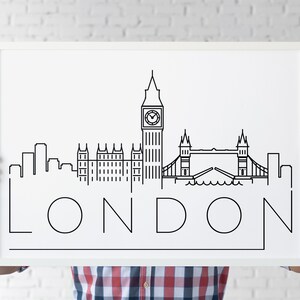 May include: A white framed poster with a black line drawing of the London skyline, including Big Ben, the Houses of Parliament, and Tower Bridge. The word "LONDON" is written in large, stylized letters below the skyline.