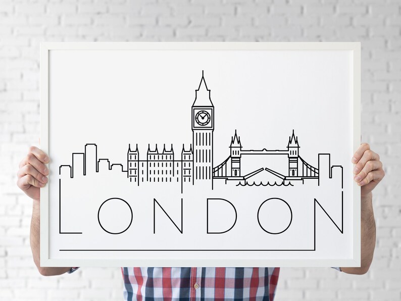 May include: A white framed poster with a black line drawing of the London skyline, including Big Ben, the Houses of Parliament, and Tower Bridge. The word "LONDON" is written in large, stylized letters below the skyline.