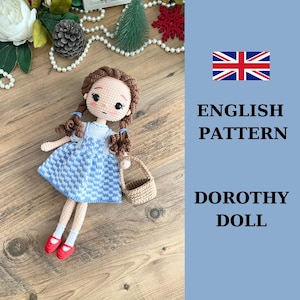 May include: Crochet pattern for a Dorothy doll from the Wizard of Oz. The pattern is in English and includes instructions for making a doll with a blue and white gingham dress, brown hair, and a basket.