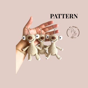 May include: Three beige crochet keychains shaped like cartoon sloths with brown noses, black eyes, and white teeth. Each figure has a metal keyring attached to the top. The text PATTERN and a circular logo with the text Pi_Bags PB are visible.