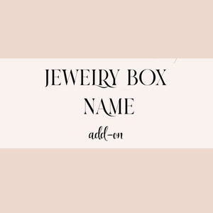 May include: A white background with black text that reads "JEWELRY BOX NAME add-on".