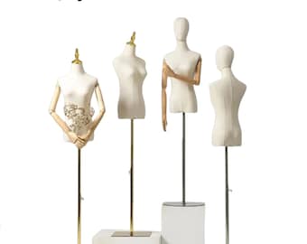 May include: Four white fabric mannequins with adjustable stands. Three mannequins have wooden arms. One mannequin has a floral design on the chest. Lilla Display is printed in red at the top of the image.