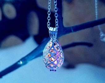 Silver Teardrop Cage Locket with Tiny Yooperlite inside.  FREE 365nm Keychain Viewing Light.  Fluorescent Sodalite.