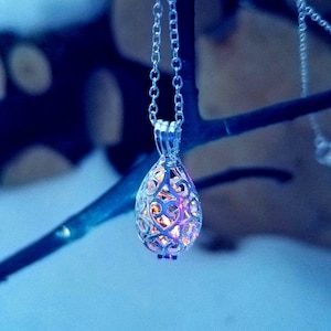 Silver Teardrop Cage Locket with Tiny Yooperlite inside.  FREE 365nm Keychain Viewing Light.  Fluorescent Sodalite.