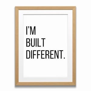 May include: A framed print with a white background and black text that reads "I'M BUILT DIFFERENT."