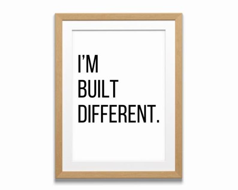 May include: A framed print with a white background and black text that reads "I'M BUILT DIFFERENT."