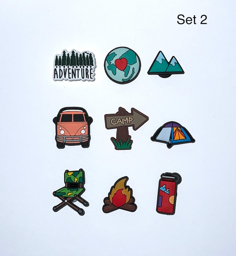 May include: Set of nine camping-themed charms. Includes a forest with the word "Adventure", a globe with a heart, mountains, a camper van, a "Camp" sign, a tent, a folding chair, a campfire, and a red thermos.