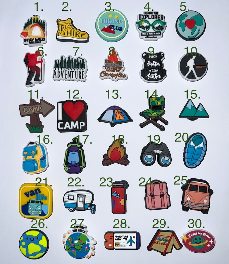 May include: A collection of 30 camping and travel-themed charms. Designs include a tent, hiking boots, a campfire, a backpack, a camper, a globe, and the text "Adventure Awaits". These charms are suitable for shoes, bracelets, or other accessories.