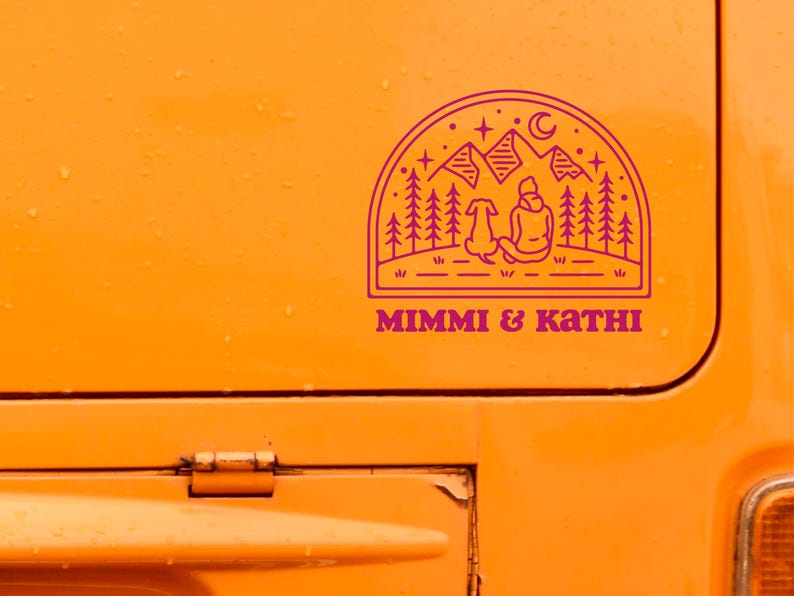 May include: A pink and white sticker with a line drawing of a person and a dog sitting in front of a mountain range with trees and stars. The text "MIMMI & KATHI" is below the drawing.