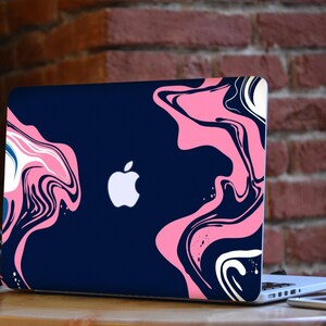May include: A laptop computer with a blue and pink marbled design on the lid. The Apple logo is visible on the lid.